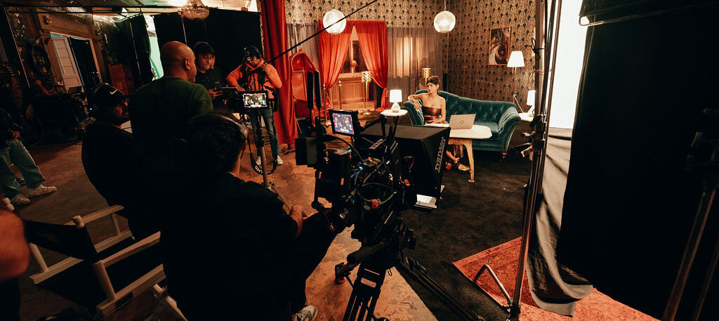 Mia Khalifa on sofa in front of Caldera Films casino set recording for casino app BJ commercial.